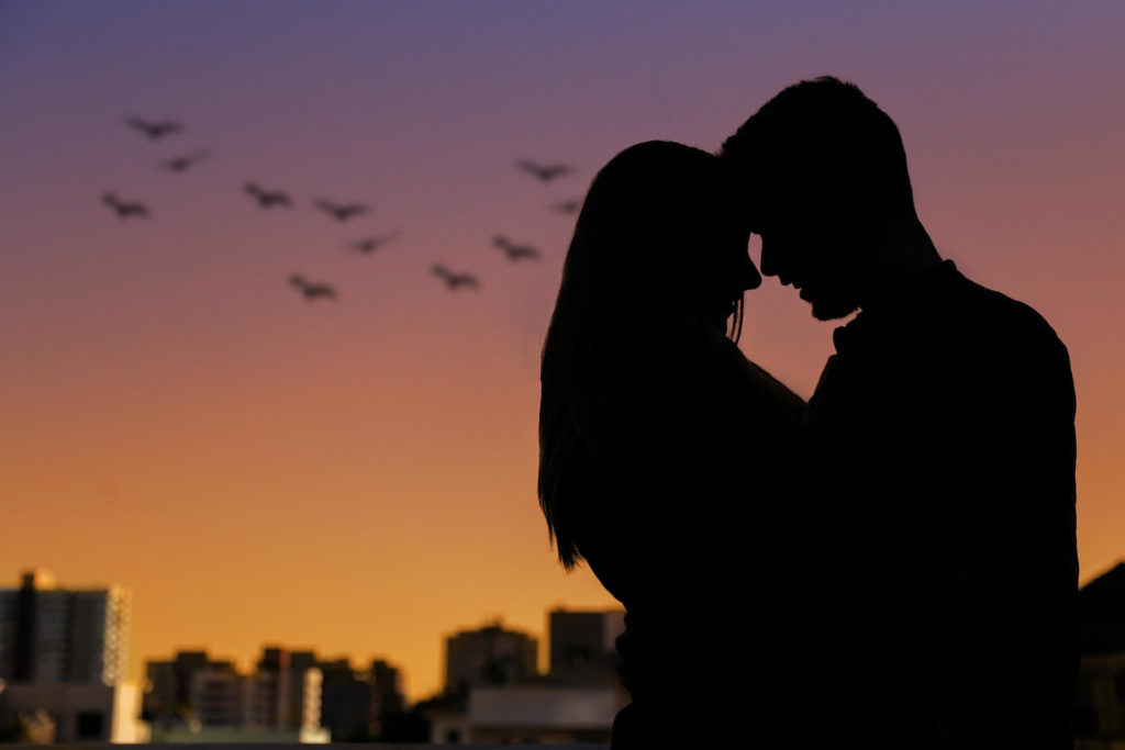 Silhouetted couple embracing